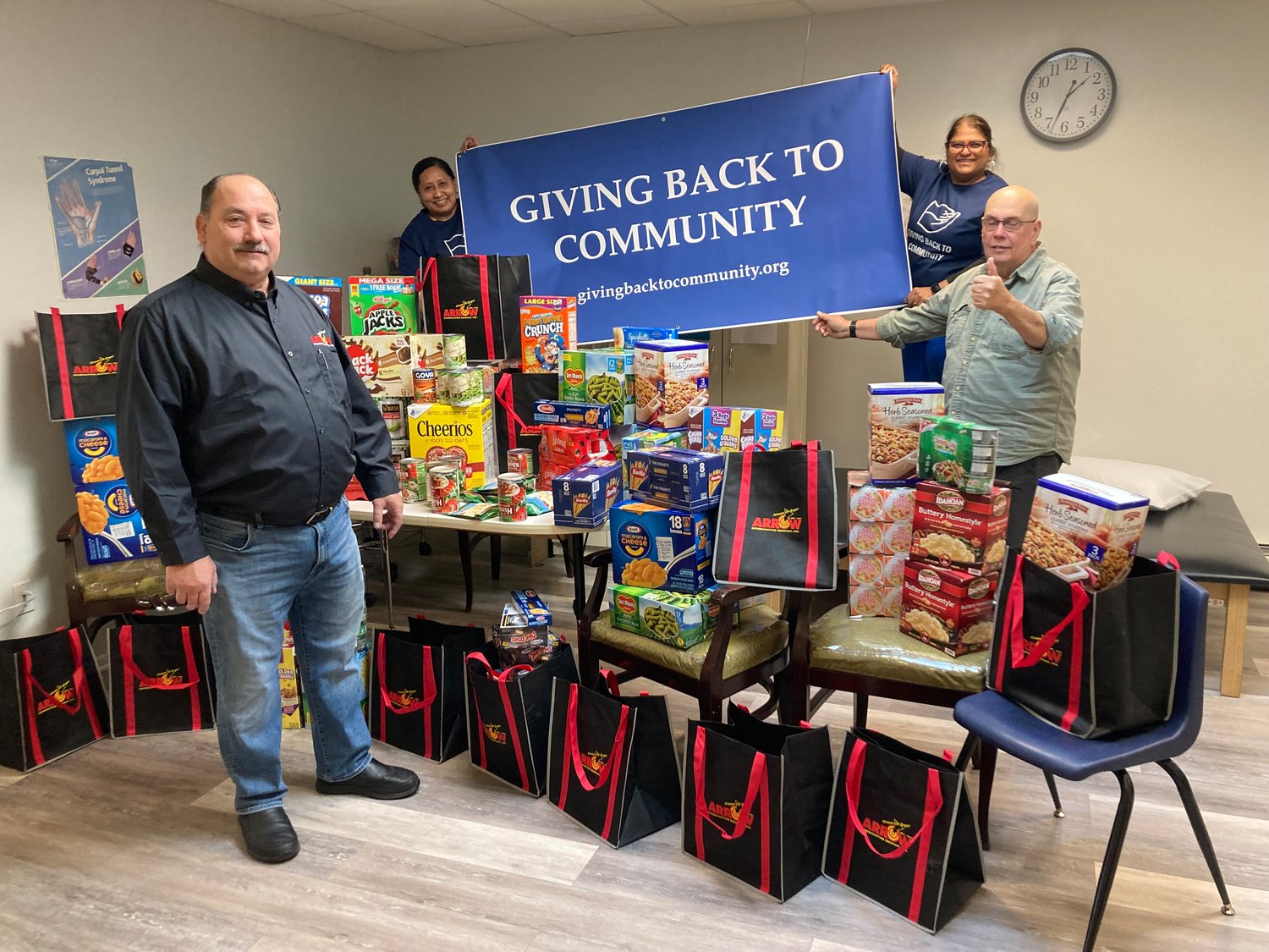 With all the food that was collected from left were Tom Jordan, Jenny DeFreitas, Luci Baijnath and Rafael Corro that included a substantial donation from Arrow Exterminating.